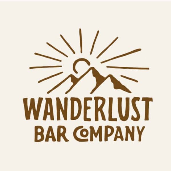 山の後ろに太陽が描かれたロゴデザイン。「Wanderlust Bar Company」